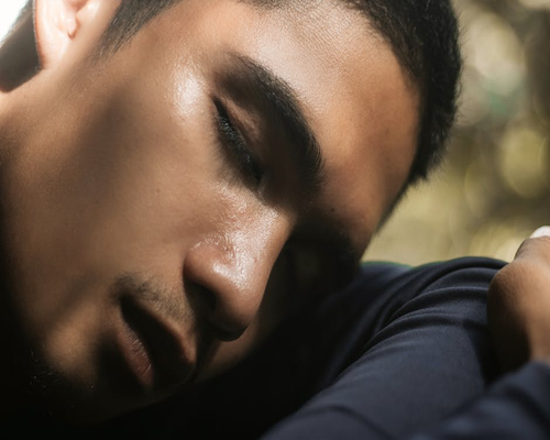 Person resting eyes while sitting outside