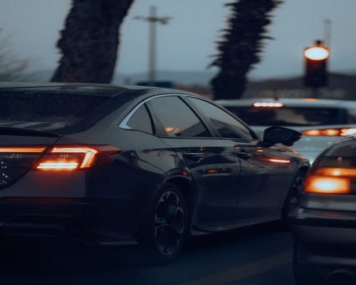 Cars in evening city traffic with glowing taillights