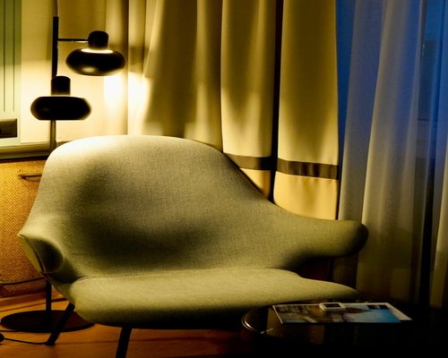 A comfortable armchair with a floor lamp for reading